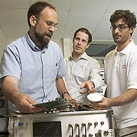 Mark Psiaki, left, professor of mechanical and aerospace engineering, hooks up an experimental GPS/Galileo digital storage receiver and patch antenna with the assistance of graduate students Todd Humphreys, center, and Shan Mohiuddin in Rhodes Hall.